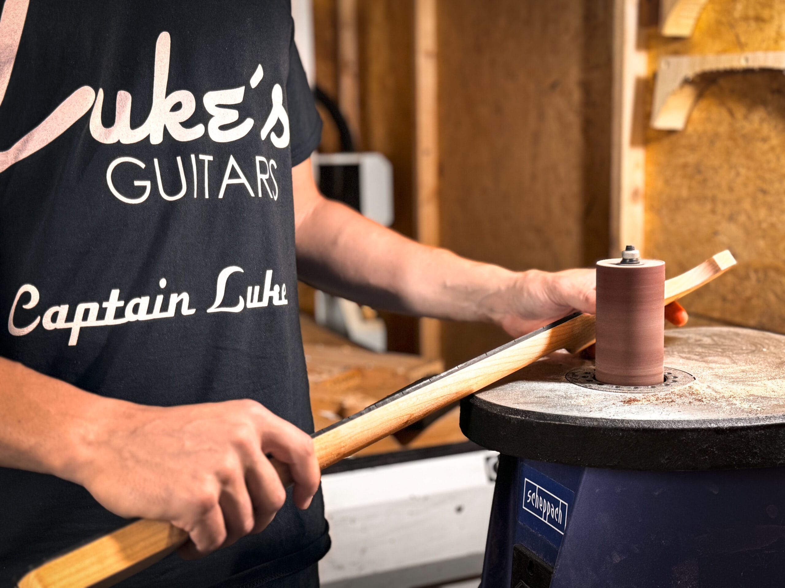 Luke shaping a neck at the workbench