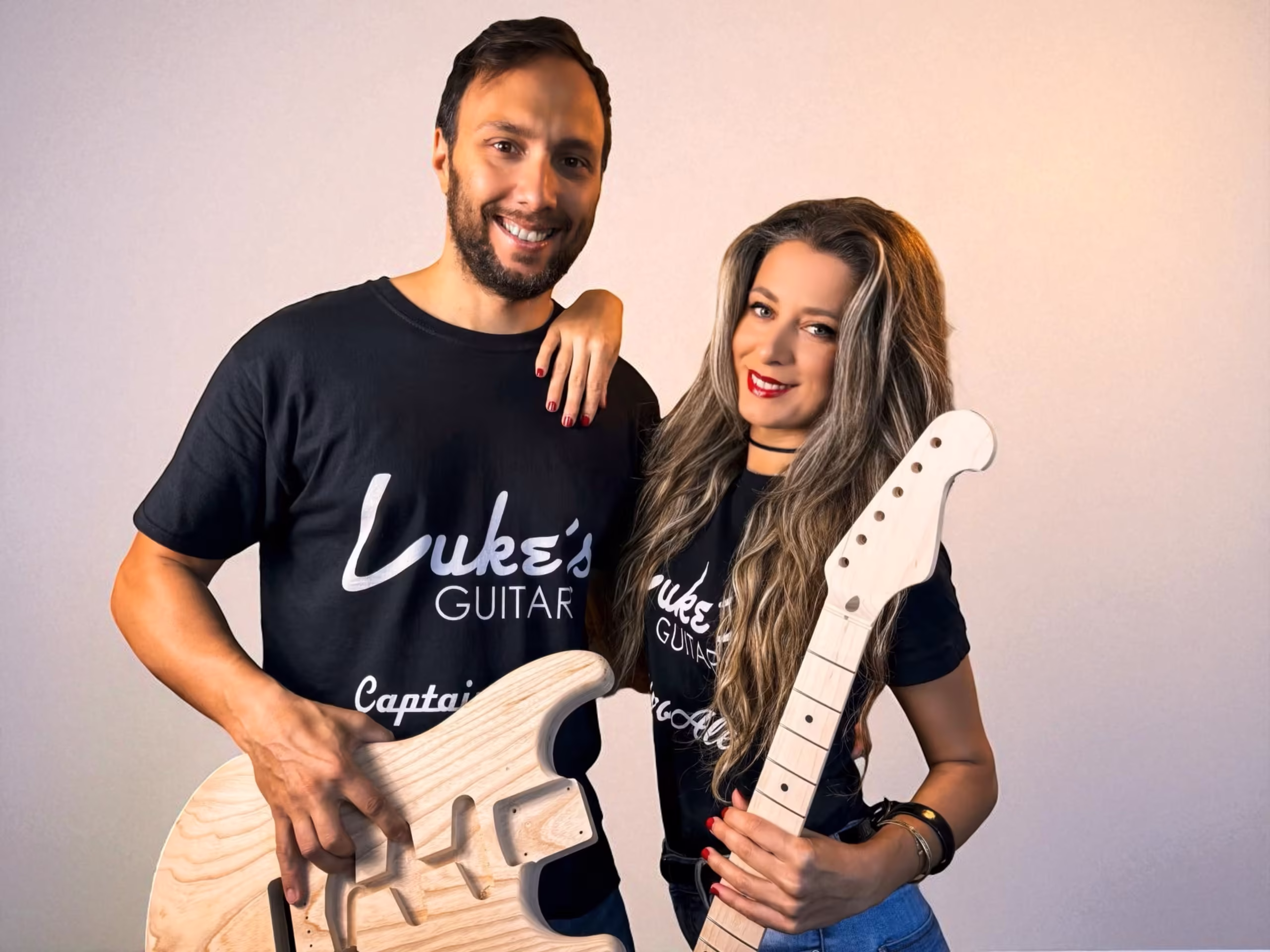 Luke and Alessia of Luke's Guitars with a raw body and neck